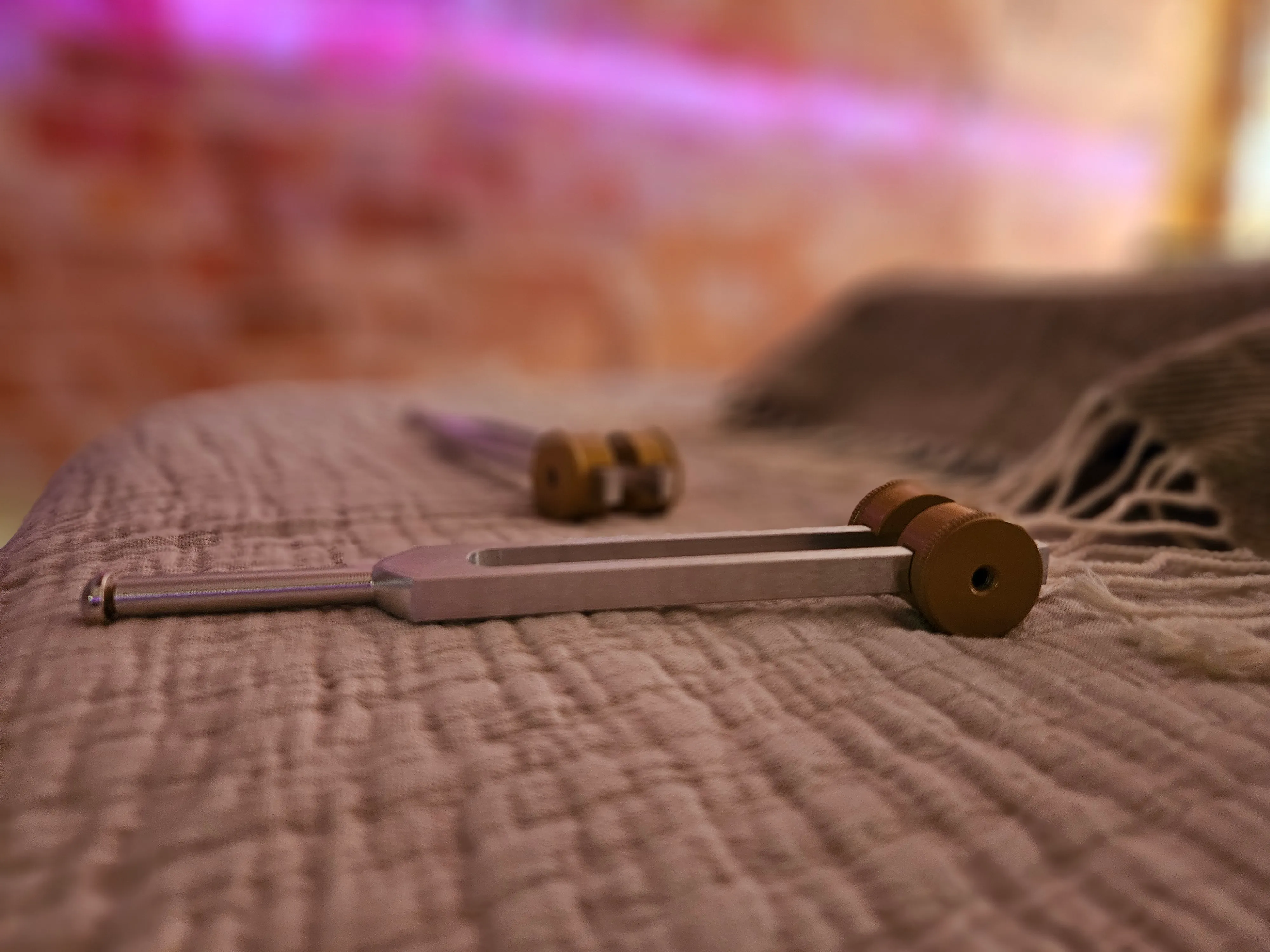 Acutonics® tuning fork resting on soft linen
